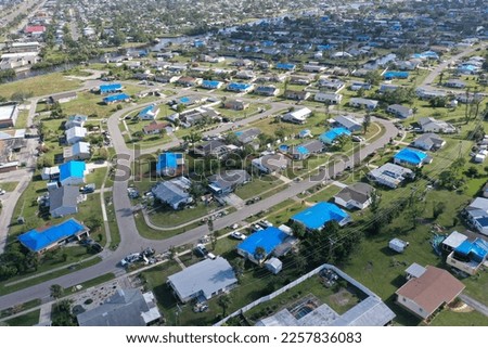 Aerial view of blue tarped roofs after hurricane Ian Port Charlotte Florida USA January 10th 2023.