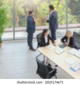 Aerial View Blurred Vertical Photo Of Caucasian Business People Wearing Suit In Small Group Meeting At The Office. Light Effect.