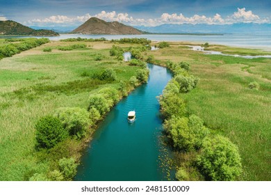 Aerial view of a boat tour on Lake Skadar, Montenegro, showcasing the scenic summer landscape and calm waters. - Powered by Shutterstock