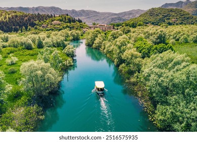 Aerial view of a boat tour on Lake Skadar, Montenegro, showcasing the scenic summer landscape and calm waters. - Powered by Shutterstock