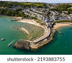 Aerial view of boats in the harbour at low tide in the Welsh seaside resort of New Quay (Ceredigion)