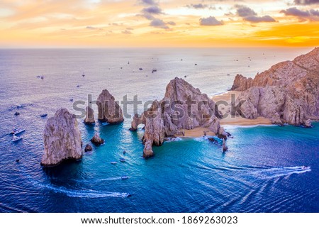 Aerial view of boats speeding by El Arco de Cabo San Lucas, Mexico at sunset, Baja California Sur