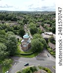 An aerial view of Bournville, Birmingham with numerous houses and a church with a green dome