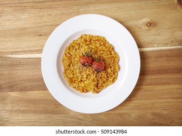 Aerial View Of A Bowl Of Tomato Risotto On A Wooden Kitchen Counter Background