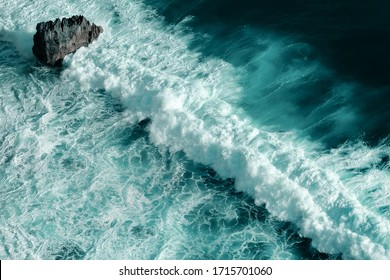 Aerial view of breaking ocean waves. Close up shot of a blue foaming waves - Powered by Shutterstock