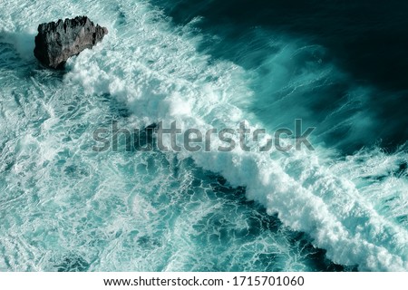 Aerial view of breaking ocean waves. Close up shot of a blue foaming waves