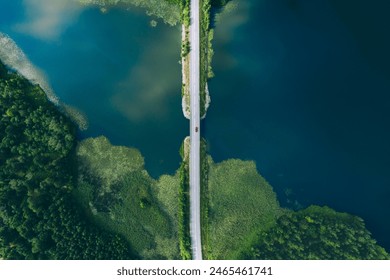 Aerial view of bridge asphalt road with cars and blue water lake and green woods. Beautiful summer landscape in Finland. - Powered by Shutterstock