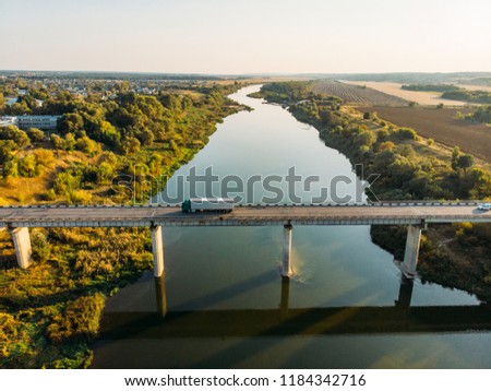 Aerial view of bridge over Don river in Voronezh, autumn landscape from above view with highway road and car transportation, toned