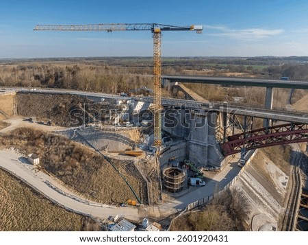 Aerial view of bridge replacement construction. The Levensau High Bridge that spans the Kiel Canal under replacement construction. The bridge replacement. Construction vehicle on construction site. 