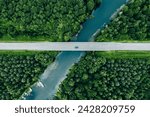 Aerial view of bridge road with car over blue river and green summer woods in Finland