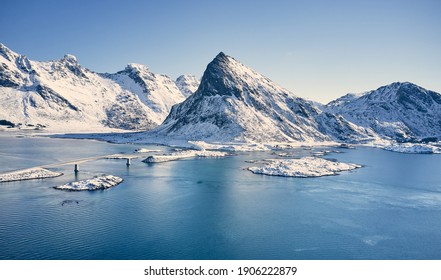 Aerial view of the bridge and snow-capped mountains in the Lofoten Islands. - Powered by Shutterstock