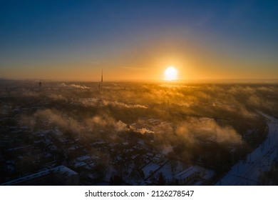 Aerial view of bright yellow sunset over white dense clouds with blue sky overhead. - Shutterstock ID 2126278547