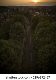 Aerial View Of A British Train Line Leading Towards Sunset