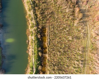 Aerial View Of A Broken Lamp Post On The Field Beside The Sea