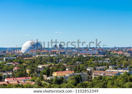 Aerial view of buildings surrounded by green trees, of Stockholm Globe Arena located on Södermalm district, Stockholm,Sweden. Space, place for your text. Blue sky on background. Stadium Ericsson Globe