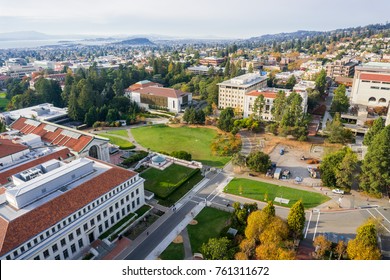 Aerial view of buildings in University of California, Berkeley campus on a sunny autumn day, view towards Richmond and the San Francisco bay shoreline in the background, California