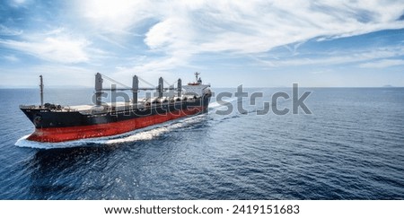 Aerial view of a bulk carrier cargo vessel traveling with high speed over blue sea with copy space as a concept for import and export industry Stock foto © 