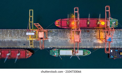 Aerial view bulk carrier dock, Global business import export logistic and transportation company, Commercial dock container cargo vessel freight shipping worldwide.