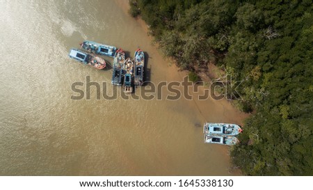 Aerial view of bunch of abandon fishing boats in a river.
