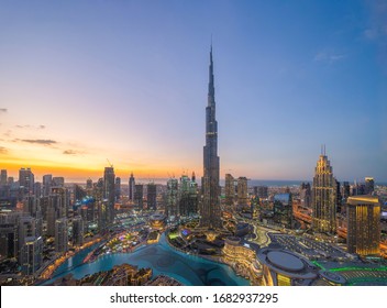 Aerial view of Burj Khalifa in Dubai Downtown skyline and fountain, United Arab Emirates or UAE. Financial district and business area in smart urban city. Skyscraper and high-rise buildings at sunset.