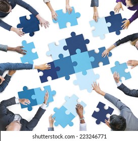 Aerial View Of Business People Piecing Puzzle Pieces