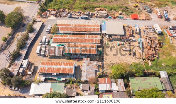 Aerial view of busy industrial under\
construction site workers working with excavators in local factory\
industry. Top view. Development\
building.