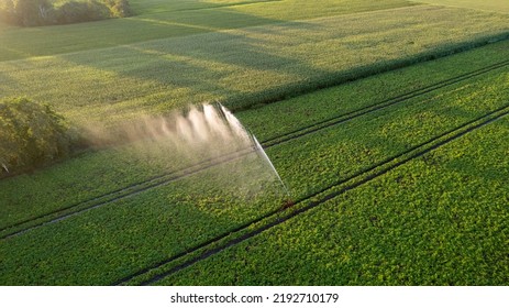 Aerial view by a drone of a potato field being irrigated by a gigantic and powerful irrigation system. High quality photo - Shutterstock ID 2192710179