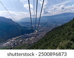 Aerial view from cable car way up of Italian City of Bolzano with scenic landscape on a sunny summer day. Photo taken July 17th, 2024, Bozen Bolzano, Italy.