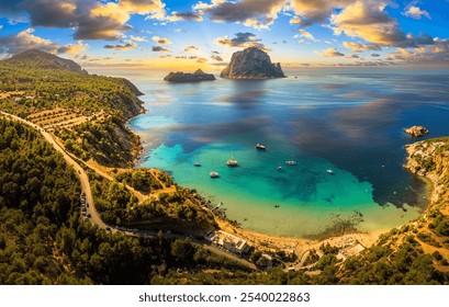 Aerial view of Cala d’Hort beach in Ibiza, featuring the iconic Es Vedrà rock, turquoise waters, and scenic Mediterranean coastline. - Powered by Shutterstock