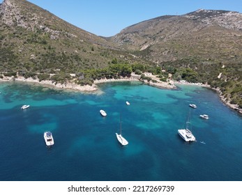 Aerial view of Cala Moresca and Figarolo Island in Golfo Aranci, north Sardinia. Birds eye from above of yacht, boats, crystalline and turquoise water. Tavolara Island in the background, Sardegna. - Shutterstock ID 2217269739