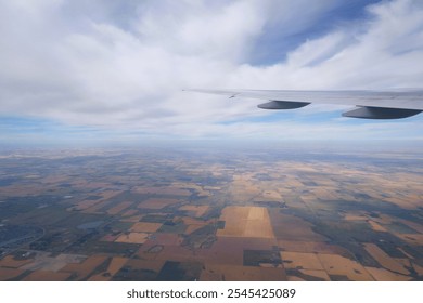 Aerial View of Calgary City and Vast Fields in Alberta, Canada from an Airplane Window