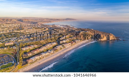 Aerial view of California coast and Dana Point harbor in Orange County on a sunny day.