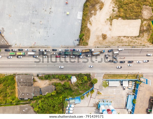 Aerial view from camera drone of\
street with traffic jam caused by accident around a\
U-turn