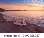 Aerial view. Camper car rv camping on coast sea shore at sunrise. Adventure, travel with mobile home.