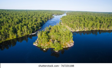 Aerial view of camping on the edge of a river during a family canoe trip - Shutterstock ID 767231188