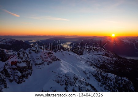 Aerial view of Canadian Mountain Landscape during a vibrant sunset. Taken near Squamish, North of Vancouver, British Columbia, Canada.