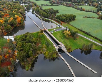 Aerial View Of A Canal Lock With A Waterfall On The Side.