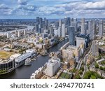  Aerial view of the Canary Wharf business district in London. Panoramic of the skyscrapers in London. Canary Wharf is part of London