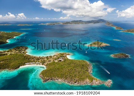 Aerial view of Caneel Bay on the island of St. John with St. Thomas in the distance in the United States Virgin Islands.