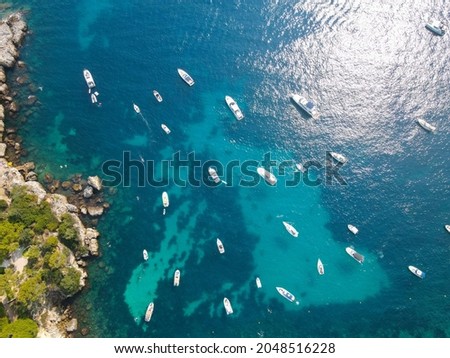 Aerial view of Cap d'Antibes and  Billionaire's Bay. Plage de l'argent faux. Beautiful rocky beach near coastal path on the Cap d'Antibes, Antibes, France. Drone view of Côte d’Azur.