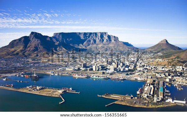 Aerial view of Cape\
Town city centre, with Table Mountain, Cape Town Harbour, Lion\'s\
Head and Devil\'s Peak