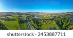 Aerial view capturing the evening glow of summer sunrise bathing the city of Liberec and the iconic Jested Mountain Ridge in warm light, with the serene landscape. Czechia