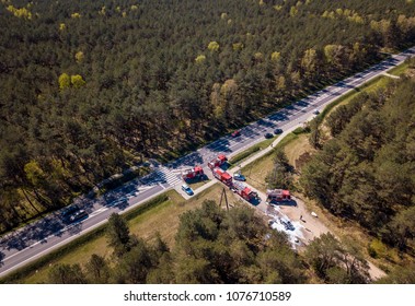 Aerial View Of A Car Accident, Police, Firefighters And An Asphalt Road In A Summer Forest