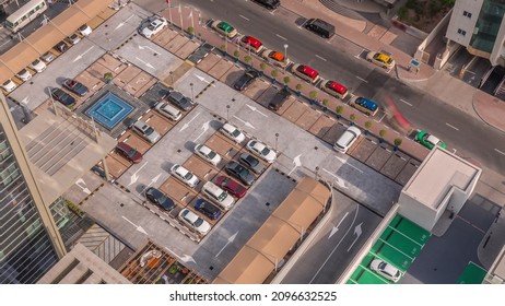 Aerial View Of Car Crowded Parking Lot Near Apartment Buildings Timelapse At Morning. Row Of Taxi Cabs Waiting Near A Road. Shadows Moving Fast