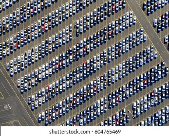 Aerial View Of A Car Distribution Centre, New Cars Parked In Rows On A Lot Ready For Sale,