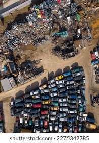 aerial view of a car dump, where a machine is seen separating old cars into scrap. - Shutterstock ID 2275342785