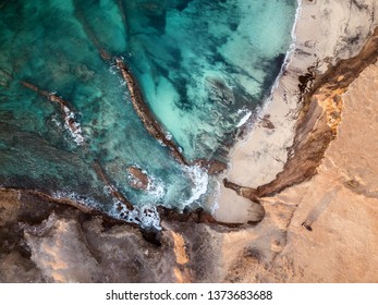 Aerial View Of A Car, Parked At The Edge Of The Cliff, Of Beautiful Fuerteventura's Coastline