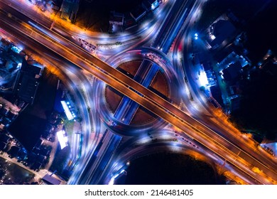 Aerial View Of Car Traffic Transportation Above Circle Roundabout Road In Asian City. Drone Aerial View Fly In Circle, High Angle. Public Transport Or Commuter City Life Concept Of Economic And Energ