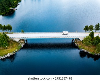 Aerial View Caravan Trailer Or Camper Rv On The Bridge Over The Lake In Finland. Summer Holiday Trip.