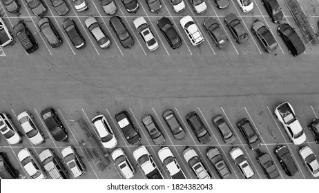 Aerial View Of Cars At Large Outdoor Parking Lots, USA. Outlet Mall Parking Congestion And Crowded Parking Lot, Other Cars Try Getting In And Out, Finding Parking Space.